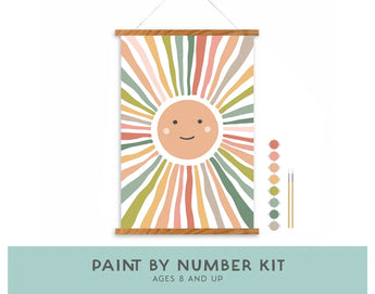 Kids Paint By Number Kit, Smiley Sunshine: sun hanging canvas, 2 brushes, & 8 acrylic paints. Text "Paint By Number Kit Ages 8 and Up."