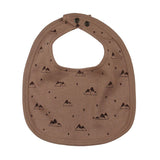 Organic Reversible Bib: brown bib with mountain pattern and snap closure.