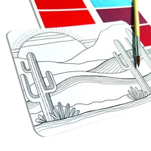 Load image into Gallery viewer, Desert landscape with cacti & mountains sketch; color it with OOLYs Desert Getaway DIY Watercolor Kit, featuring a red palette & brush.