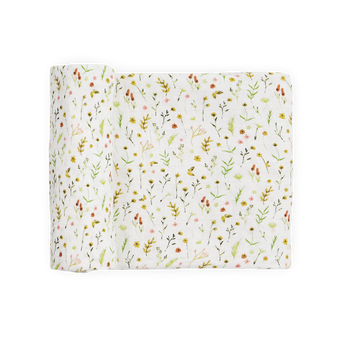 Little Unicorn Organic Cotton Muslin Swaddle—Floral Field: white with colorful wildflowers & green leaves, partially rolled.