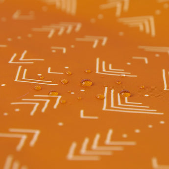 Close-up of water droplets on Bumkins Short-Sleeved Smock: Grounded.