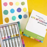 Life of Colour Pastel Gouache Paint Stix: 12 mess-free tools on a yellow surface, with a sheet displaying colored dots.