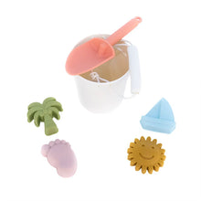 Load image into Gallery viewer, Emerson and Friends Beach Bucket Toy Play Set: silicone bucket with pink shovel and pastel sea-themed molds like palm tree, foot, sun, sailboat.