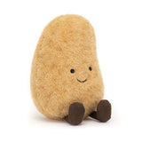 Jellycat Amuseable Potato is a plush toy with a smile and little brown feet, sitting upright against a white background.