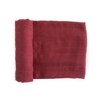 Deluxe Muslin Swaddle in Dusty Maroon by Little Unicorn, folded with a grid pattern and partially rolled on a white background.