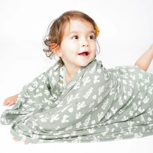 Load image into Gallery viewer, A toddler smiles, wrapped in Emerson and Friends Stay Sharp bamboo blanket featuring a cactus print.