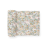 Little Unicorn Stretch Knit Swaddle Blanket in Pressed Petals: white with green, orange, and yellow floral print.