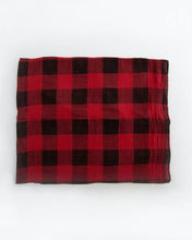 Load image into Gallery viewer, Little Unicorn Cotton Swaddle in Red Plaid laid flat on a white background.