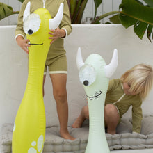 Load image into Gallery viewer, Two kids in matching outfits play indoors with Sunnylifes Monty the Monster inflatable pool noodles, sparking their imaginations.