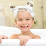 A smiling child enjoys bubbles with foam animal ears in a Piggy Paint 3-in-1 Shampoo + Body Wash + Bubble Bath.