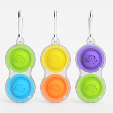 Load image into Gallery viewer, Pet bowls with colorful tactile designs in blue/green, yellow/orange, and purple/green come with carabiners. Brand: Fat Brain Toy Co.