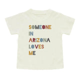 Emerson and Friends Luxury Tee for kids features Someone in Arizona colorful text on a white, unique luxury cotton shirt.