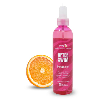 A pink Vita C After Swim Detangler bottle, a chlorine neutralizer, sits by sliced orange on a white background.