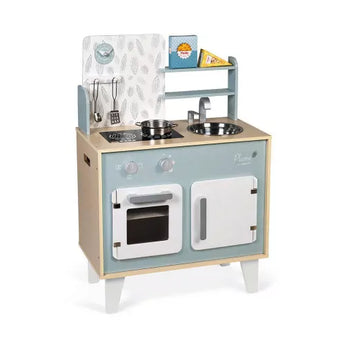 A Janod Plume Cooker kitchen set featuring a stove, sink, oven, and accessories including a pot and play food.