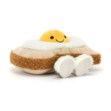Jellycat Amuseables Egglantine Egg on Toast: a plush, smiling fried egg with fuzzy brown edges and soft white feet lying on its side.