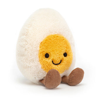 Jellycat Amuseables Happy Boiled Egg: a plush toy with a smiley yolk face and corduroy legs, sits upright.