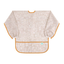 Load image into Gallery viewer, Bumkins Long-Sleeved Art Smock: Wander—beige waterproof fabric with white abstract design, orange trim, front pocket, and adjustable tie closure.