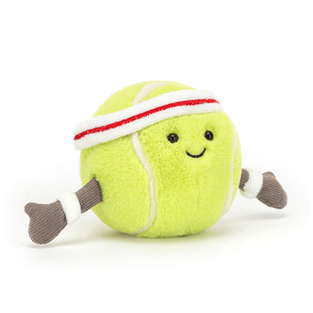 A smiling Jellycat Amuseables Sports Tennis Ball plush with brown arms and a white and red sweatband.