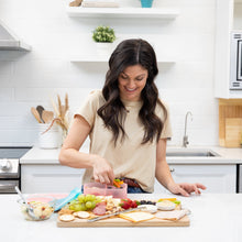 Load image into Gallery viewer, In the kitchen, a woman organizes snacks into a Bumkins Silicone Bento Box 3 Section: Pink Jelly on a fruit-lined counter.