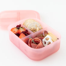 Load image into Gallery viewer, Bumkins Silicone Bento Box 3 Section: Pink Jelly holds fruit, crackers, meat, and yogurt pretzels on a white background.