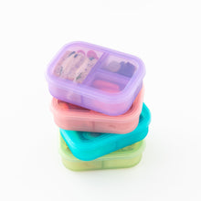 Load image into Gallery viewer, A stack of colorful bento boxes filled with snacks, including a Bumkins Silicone Bento Box 3 Section: Purple Jelly, on a white background.