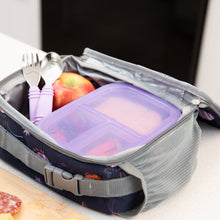 Load image into Gallery viewer, Bumkins Spoon + Fork: Lavender sit in an open lunch bag with an apple and a transparent purple bento box on a kitchen counter.