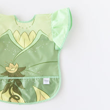 Load image into Gallery viewer, Bumkins Ruffle Apron Bib: Tiana is shown on a white background, partially out of frame.