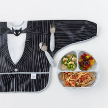 Load image into Gallery viewer, Bumkins Sleeved Bib: Jack Skellington lays flat on a white background next to a divided plate filled with food and matching utensils.