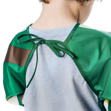 Load image into Gallery viewer, A child wearing a Bumkins Sleeved Bib: Zelda™ has their back to the camera, showcasing the ribbon neck closure.