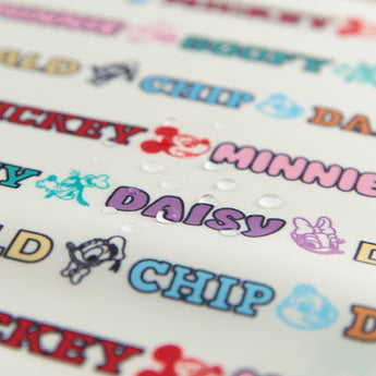 Close-up of water droplets on a Bumkins Clear Travel Bag 3 Pack: Mickey & Friends Varsity.