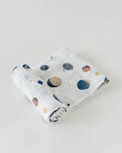 Load image into Gallery viewer, The Little Unicorn Cotton Swaddle, Planetary features hand-painted space-themed prints of planets and stars on light gray cotton muslin.