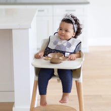 Load image into Gallery viewer, A toddler wearing a bib and headband sits in a high chair, with a Bumkins Silicone First Feeding Set: Minnie Mouse on the tray.