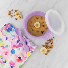 Load image into Gallery viewer, Bumkins Silicone First Feeding Set: Lavender with applesauce surrounded by banana slices, granola, and a floral pouch on a marble surface.