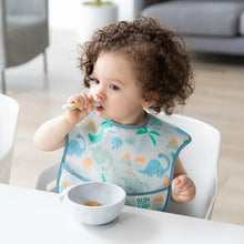 Load image into Gallery viewer, A curly-haired toddler in dinosaur bib eats from a Bumkins Silicone First Feeding Set: Marble at a white table.