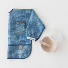 Load image into Gallery viewer, Bumkins Silicone First Feeding Set: Sand rests next to a folded denim print sleeved bib on a white background.