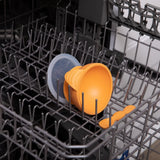 Bumkins Silicone First Feeding Set: Tangerine sits in the top rack of an open dishwasher.