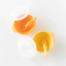 Load image into Gallery viewer, Bumkins Silicone First Feeding Set: Tangerine sits next to a yellow bowl and spoon set on a white background.