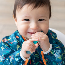Load image into Gallery viewer, A joyful baby in a blue bib chews a spoon from Bumkins Silicone First Feeding Set: Blue Jelly.
