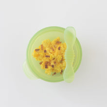 Load image into Gallery viewer, Top down view of Bumkins Silicone First Feeding Set: Green Jelly with yellow scrambled eggs and bacon bits on a white background.