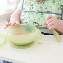 Load image into Gallery viewer, Close-up of a baby in a high chair wearing a green bib, eating puree from a Bumkins Silicone First Feeding Set: Green Jelly.