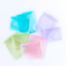 Load image into Gallery viewer, Bumkins Silicone Flat Reusable Bag 2 Pack, Blue lays among other similar bags sets on a white background.
