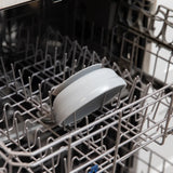 Bumkins Silicone Grip Bowl: Gray sits in the top rack of an open dishwasher.