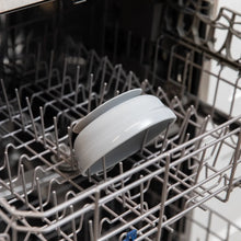 Load image into Gallery viewer, Bumkins Silicone Grip Bowl: Gray sits in the top rack of an open dishwasher.