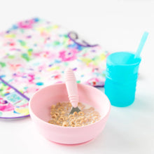 Load image into Gallery viewer, Bumkins Silicone Grip Bowl: Pink with cereal and milk, beside a blue cup with a straw and a colorful bib on a white background.