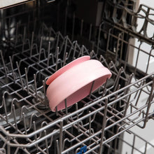 Load image into Gallery viewer, Bumkins Silicone Grip Bowl: Pink sits in the top rack of an open dishwasher.