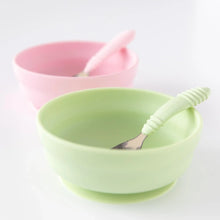 Load image into Gallery viewer, Bumkins Silicone Grip Bowl: Sage with a matching spoon on a white background, with a pink bowl and spoon blurred behind.