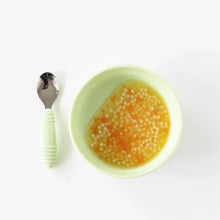 Load image into Gallery viewer, Bumkins Silicone Grip Bowl: Sage, filled with soup and pasta, sits on a white background next to a matching spoon.