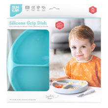 Load image into Gallery viewer, Bumkins Silicone Grip Dish: Blue in a white packaging box with a photo of a child and a clear window partially displaying the dish.