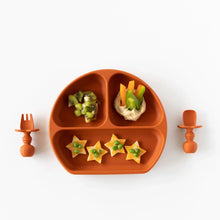 Load image into Gallery viewer, Bumkins Silicone Grip Dish: Clay with star snacks, kiwi slices, veggie sticks in hummus, and matching utensils on a white background.