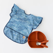 Load image into Gallery viewer, Bumkins Silicone Grip Dish: Clay lays with matching utensils next to a denim-print bib with ruffle sleeves on a white background.